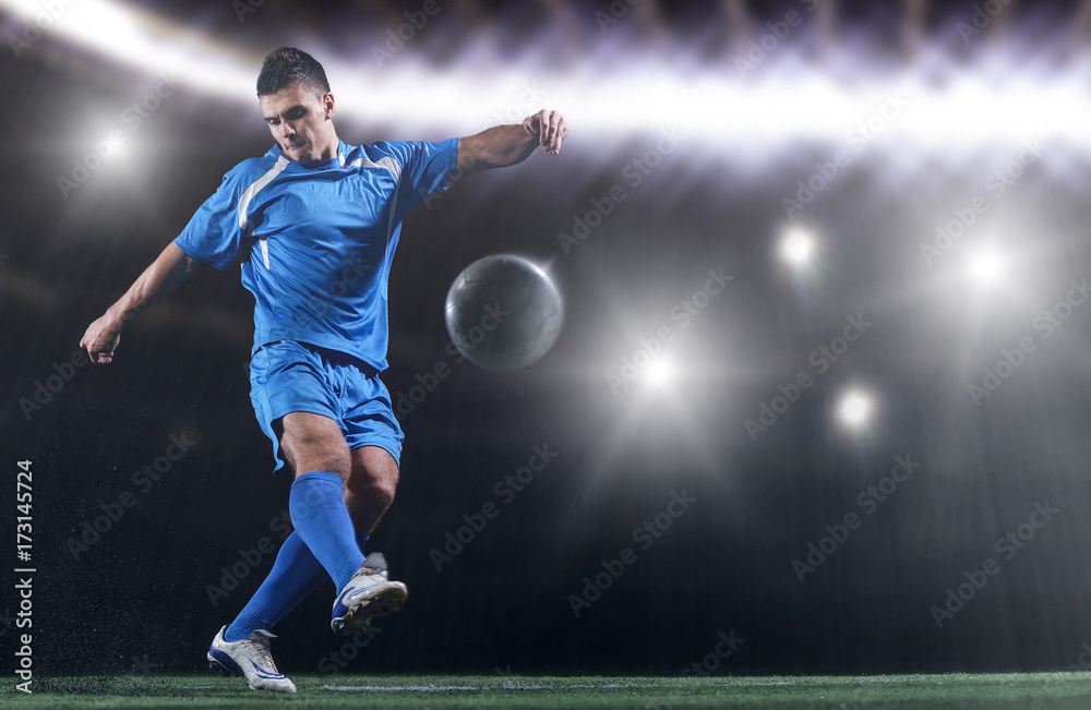 soccer player in front of big modern stadium with flares and lights soccer player in front of big modern stadium with flares and lights