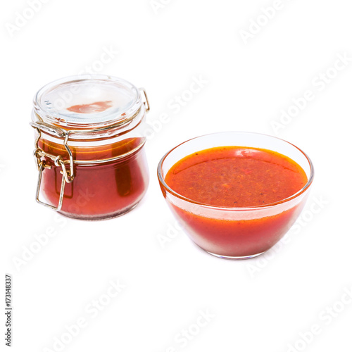 Fortified jam from fresh berries of sea buckthorn mashed with sugar in a glass jar and a vase with jam isolated on white background