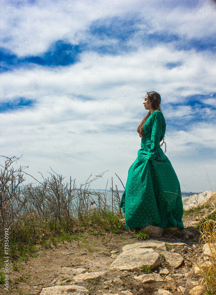 girl in green medieval dress on cliff girl in green medieval dress on cliff