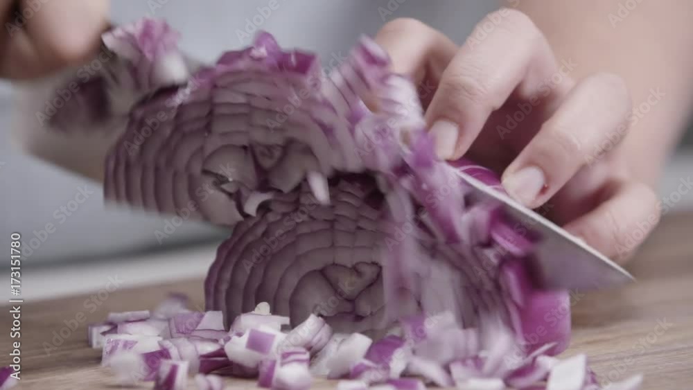 Close up, chef chops red onion