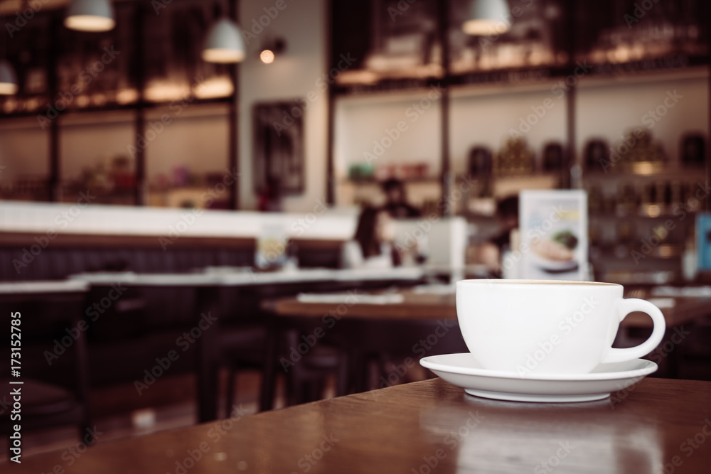 Hot latte coffee in white cup on table in restaurant and cafe Hot latte coffee in white cup on table in restaurant and cafe