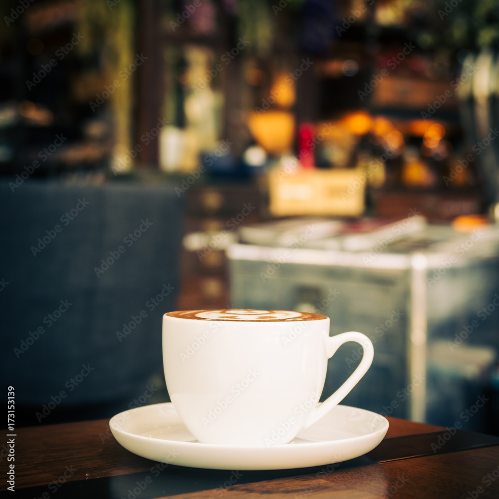 Hot latte coffee in white cup on table in restaurant and cafe Hot latte coffee in white cup on table in restaurant and cafe