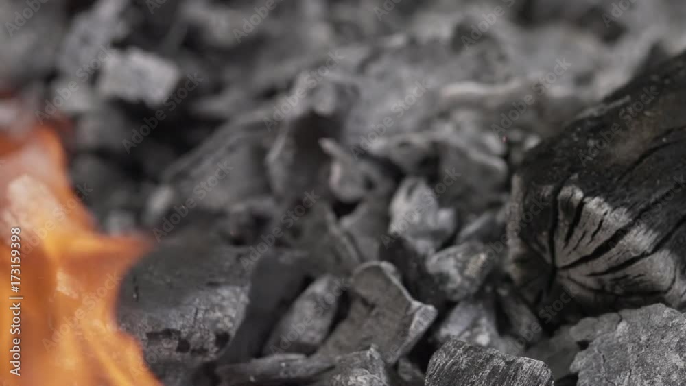 Close up, flames create ash in fire pit Close up, flames create ash in fire pit