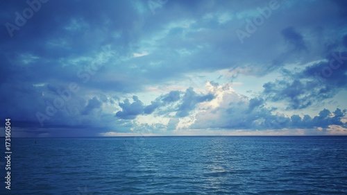 Fotografering Sea sunrise over the atlantic ocean. Rainy clouds.