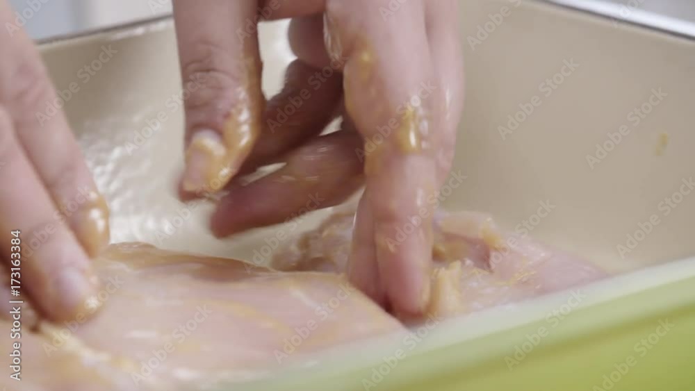 Person turns over chicken breasts, close up Person turns over chicken breasts, close up