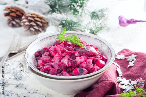 Salad with beets and herring in festive Christmas decorations, horizontal
