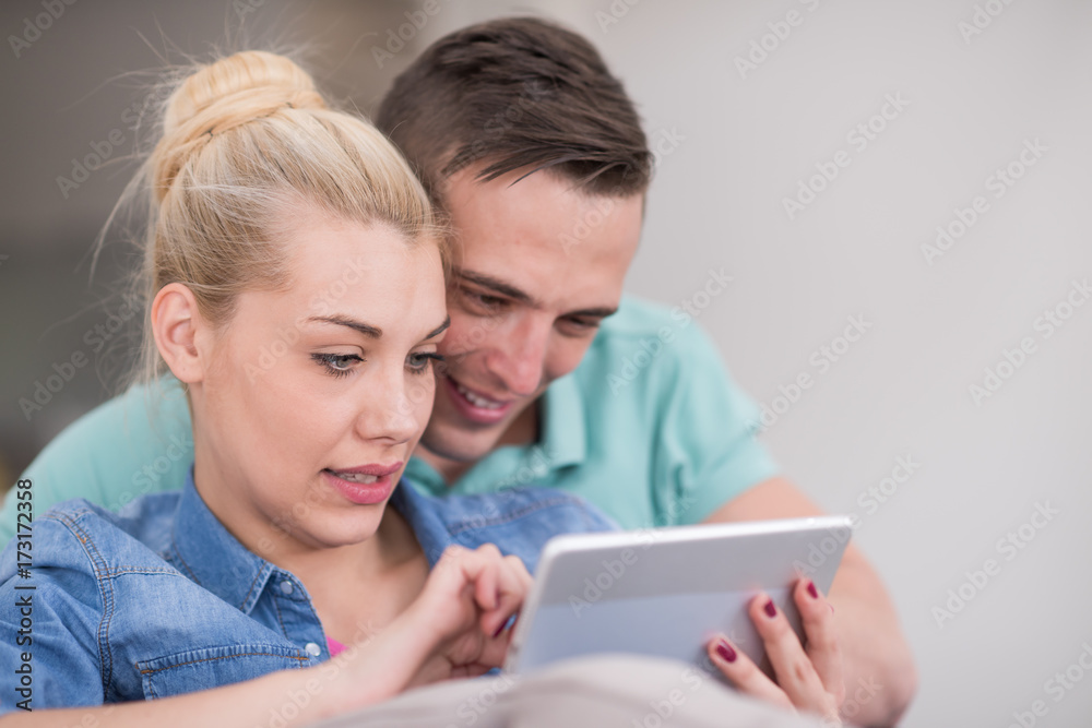 couple relaxing at home with tablet computers couple relaxing at home with tablet computers