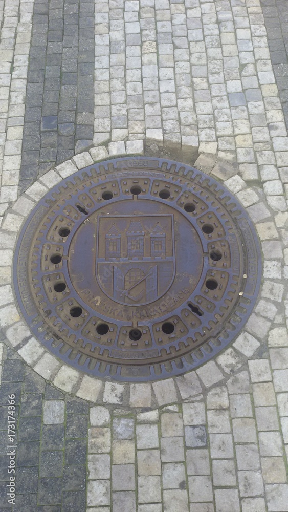 Manhole cover on a street in Prague