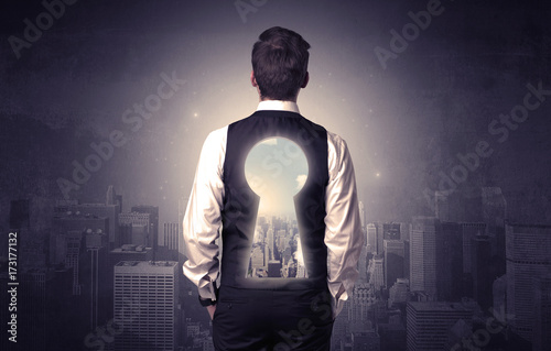 Businessman standing with keyhole on his back