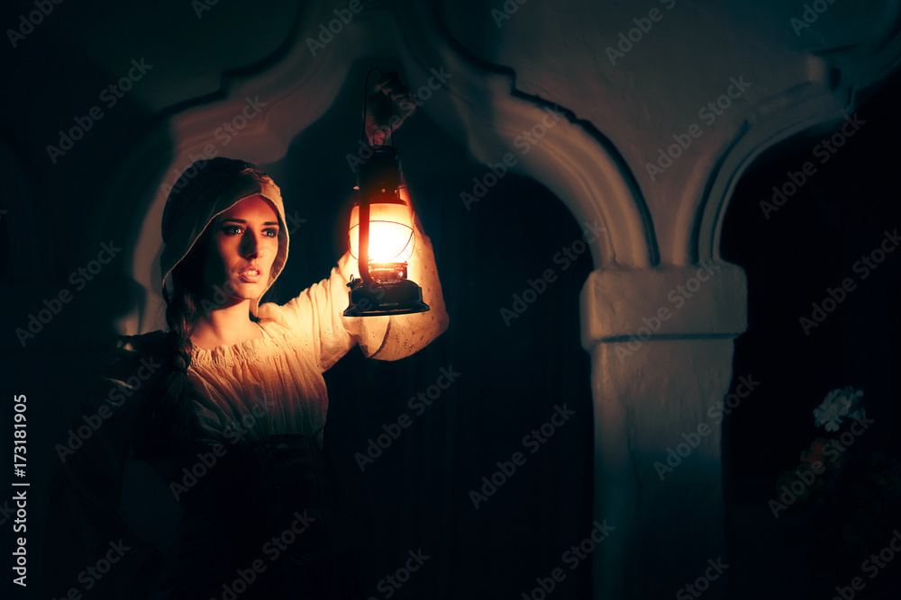 Obraz premium Medieval Woman with Vintage Lantern Outside at Night