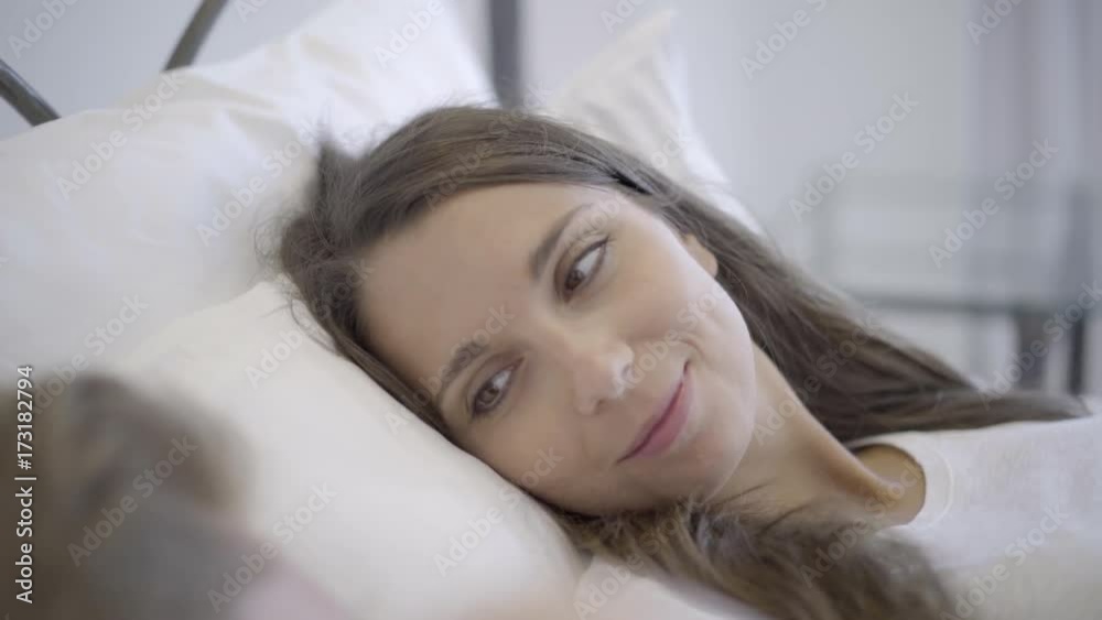 4k video closeup smiling woman in bed looking to side at her husband waking up in the morning 4k video closeup smiling woman in bed looking to side at her husband waking up in the morning