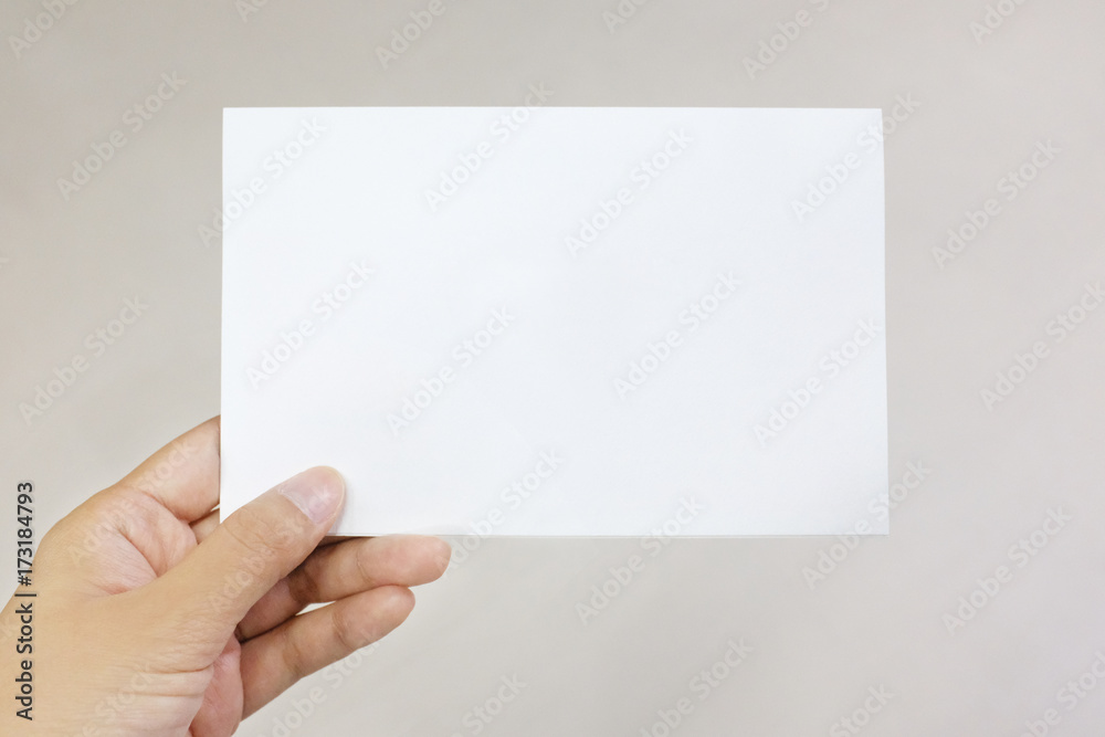 A hand holding a paper card A hand holding a paper card
