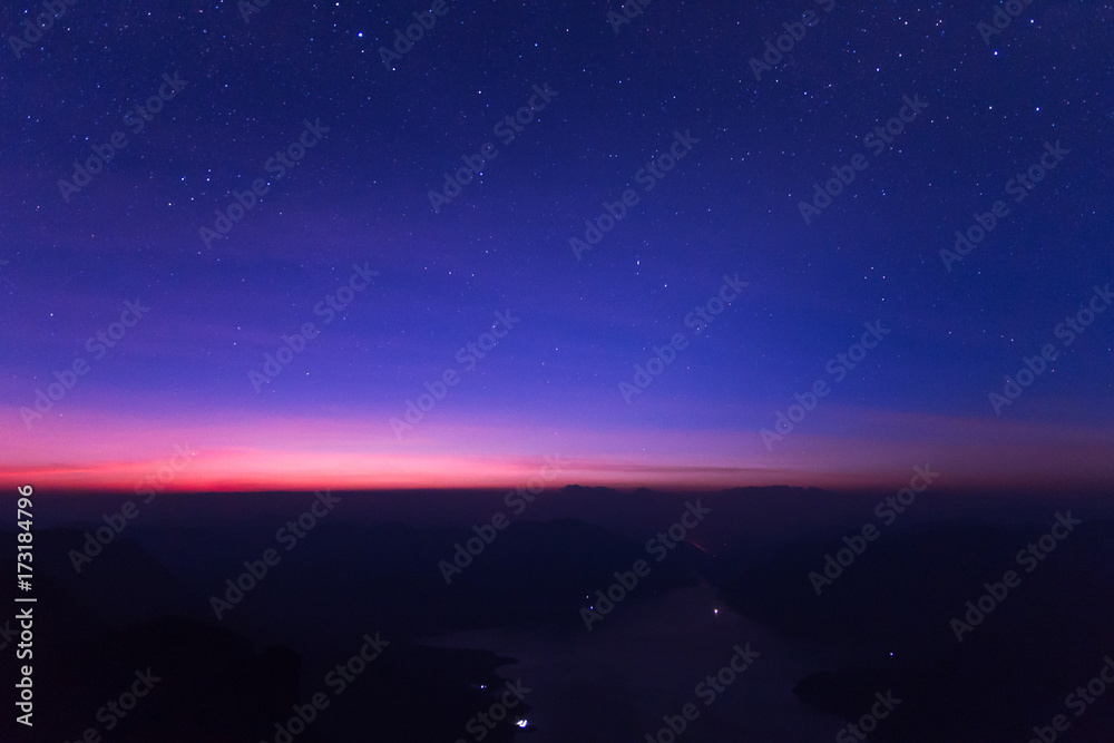 The milky way rises over the Mae Ping national park at sunrise, Pha dang luang view point  Li, Lamphun in Thailand 