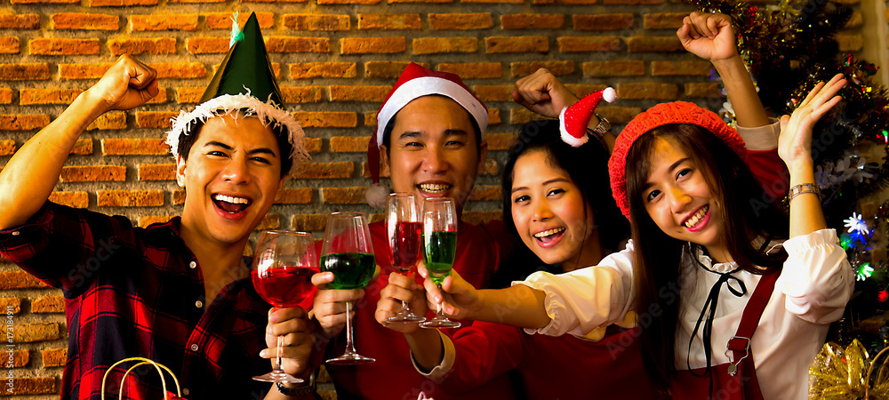 The acting setup of Christmas party concept. The two young couple enjoy together in the Xmas party and all the mambers has a drink to celebrate together. The acting setup of Christmas party concept. The two young couple enjoy together in the Xmas party and all the mambers has a drink to celebrate together.