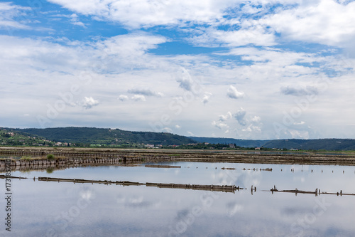 Sečovlje traditional saltworks near Piran in Slovenia blue sky reflecting in water panoramic 