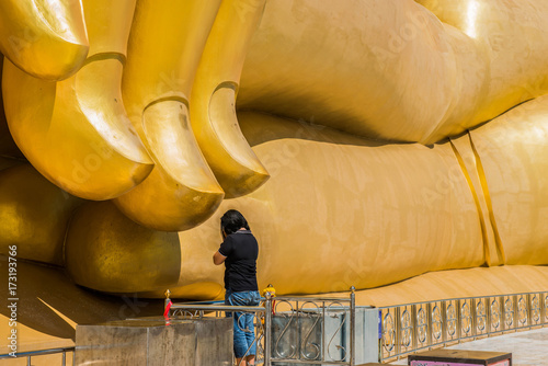 July 2017 Thailand - Woman is pay homage to Big Buddha statue at Wat Muang Thailand photo