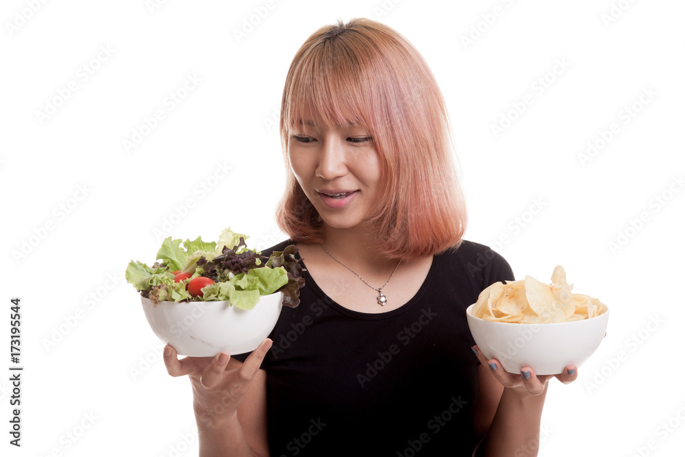 Young Asian woman with potato chips and salad. Young Asian woman with potato chips and salad.
