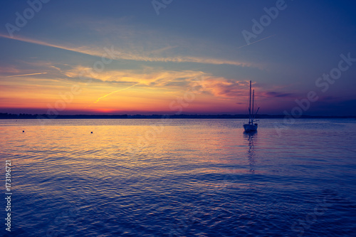 Yacht in the sea at sunset © R_Szatkowski