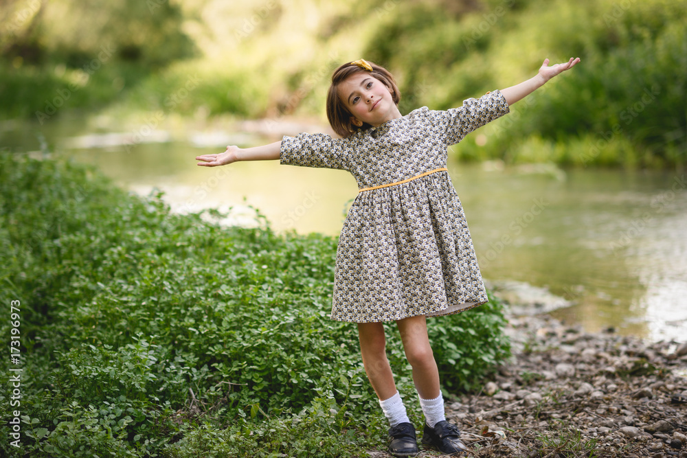 © javiindy - Little girl in nature stream wearing beautiful dress © javiindy - Little girl in nature stream wearing beautiful dress