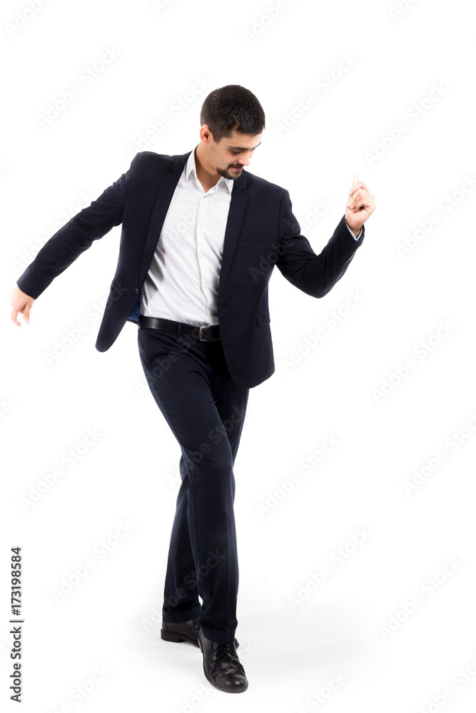 A man in a business suit, on a white background, dances, steps from foot to foot. Movement, restrained, joy, success and prosperity. Pleasant appearance.