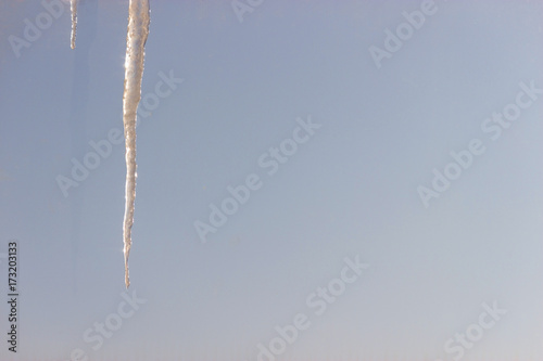 icecle on a background of blue sky photo