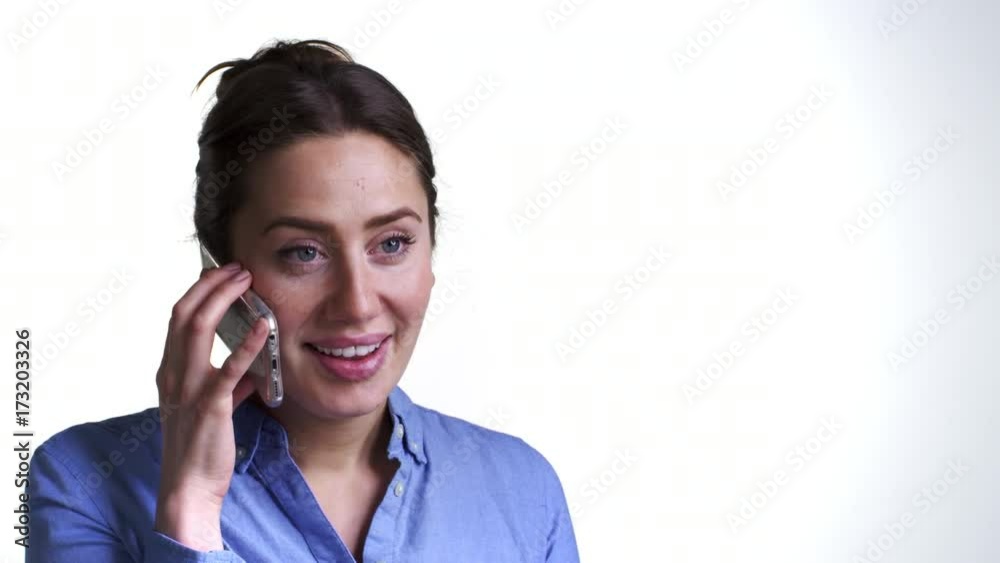 Studio Shot Of Animated Young Woman Talking On Mobile Phone Studio Shot Of Animated Young Woman Talking On Mobile Phone