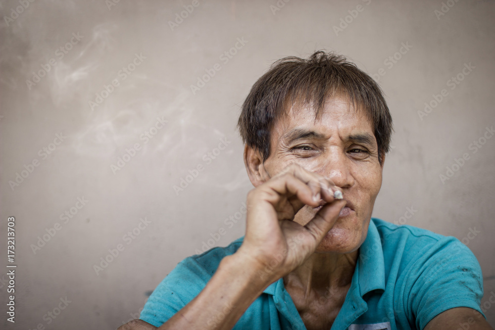 Old man is smoking. Selective focus. Soft focus. Old man is smoking. Selective focus. Soft focus.
