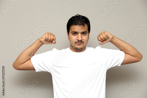 expressions of young amazed man isolated on gray background