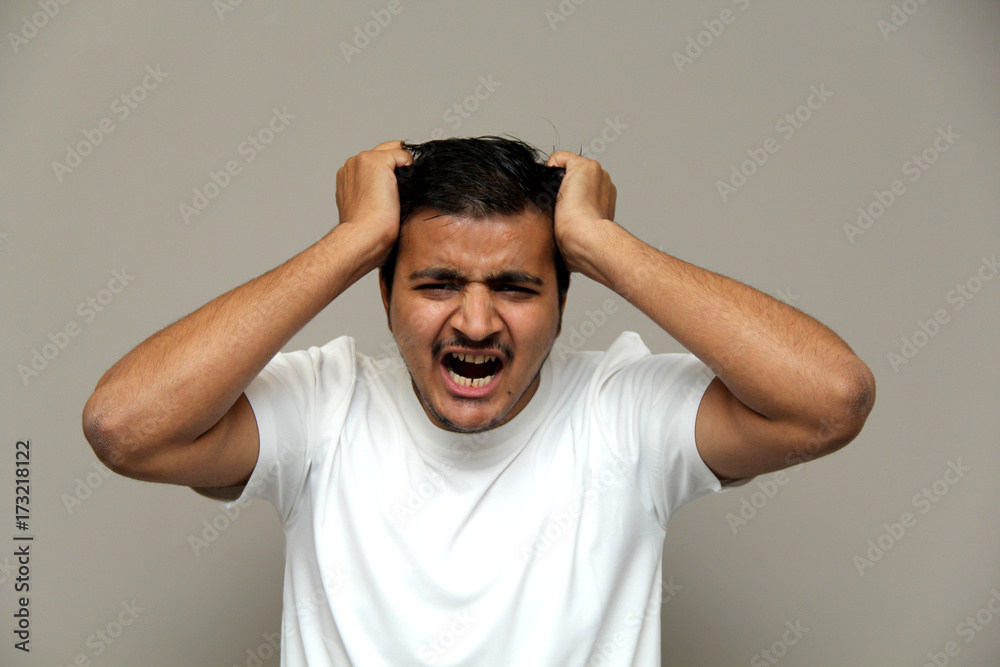 expressions of young amazed man isolated on gray background expressions of young amazed man isolated on gray background