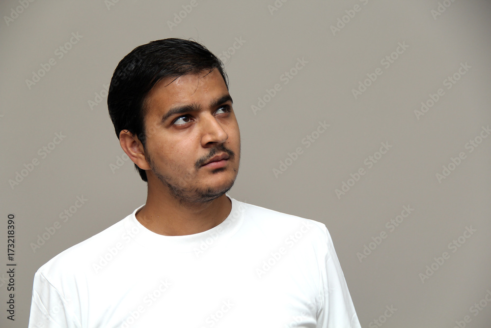 expressions of young amazed man isolated on gray background