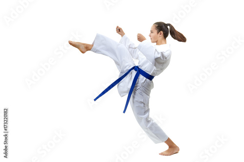 Adult girl with a blue belt beats kick leg