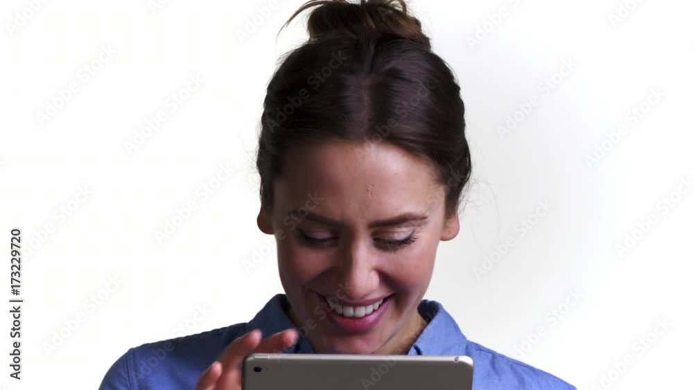 Shot Of Woman Using Digital Tablet Against White Background Shot Of Woman Using Digital Tablet Against White Background
