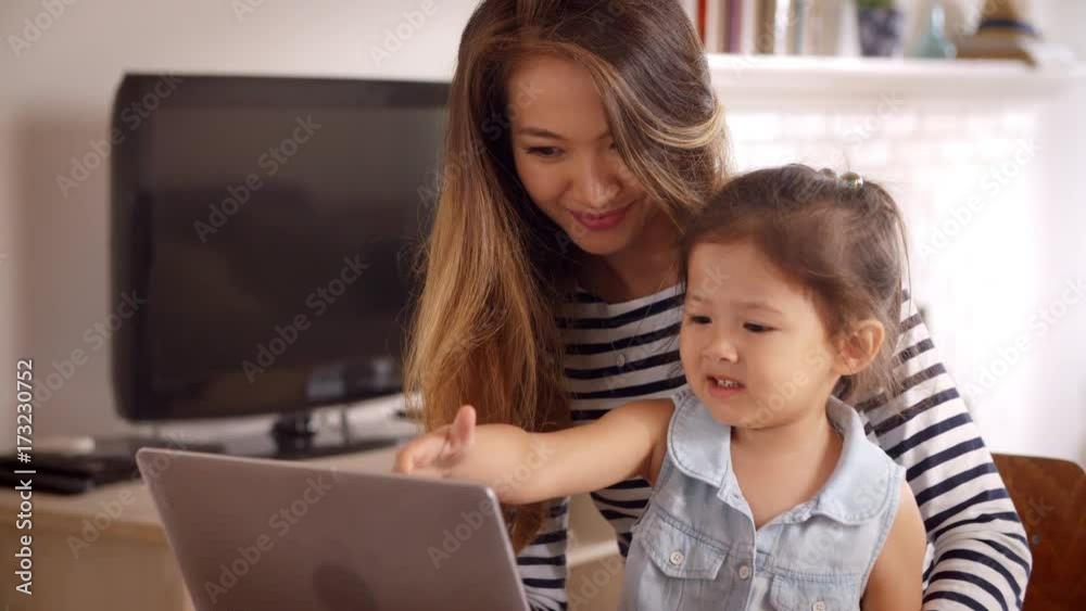Mother And Daughter Watch Movie On Laptop At Home Together Mother And Daughter Watch Movie On Laptop At Home Together