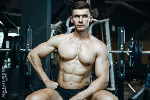 Handsome model young man working out in gym