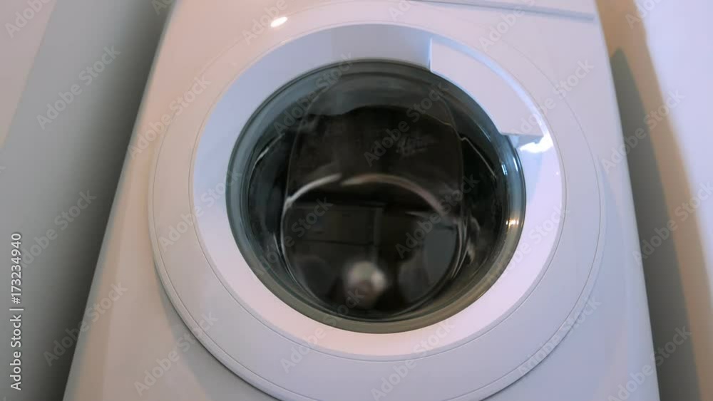 Washing machine washes laundry such as color clothing in front view Washing machine washes laundry such as color clothing in front view