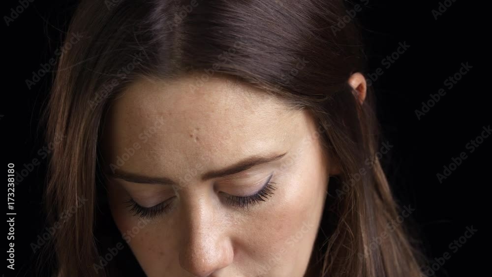 Studio Shot Of Unhappy Young Woman Crying Into Camera Studio Shot Of Unhappy Young Woman Crying Into Camera