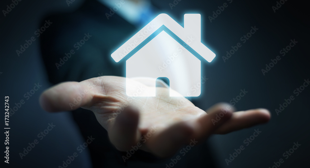 Naklejka premium Businessman holding 3D rendering icon house in his hand