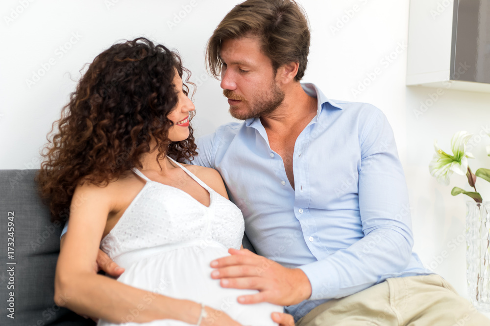 Husband touching his pregnant wife's belly Husband touching his pregnant wife's belly