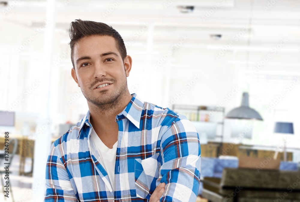 Obraz premium Portrait of happy young casual man at home