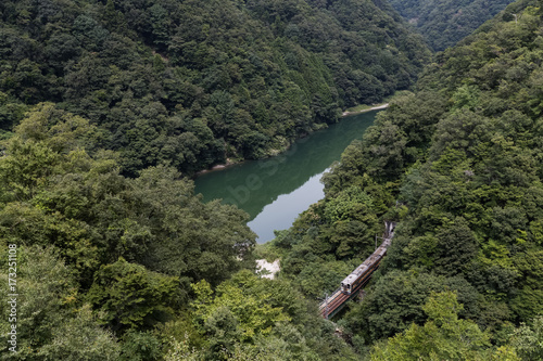 Green mountain in summer season and Japan railway lida line