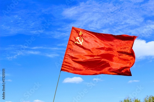 Waving flag of the USSR against the blue sky.