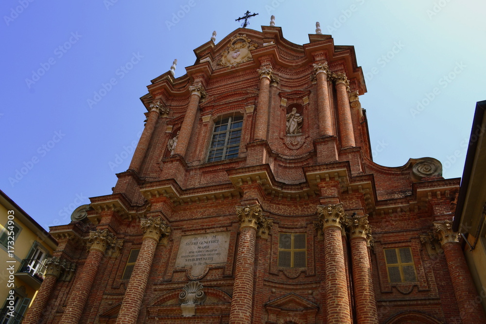 Large red brick church in the city Chieri 