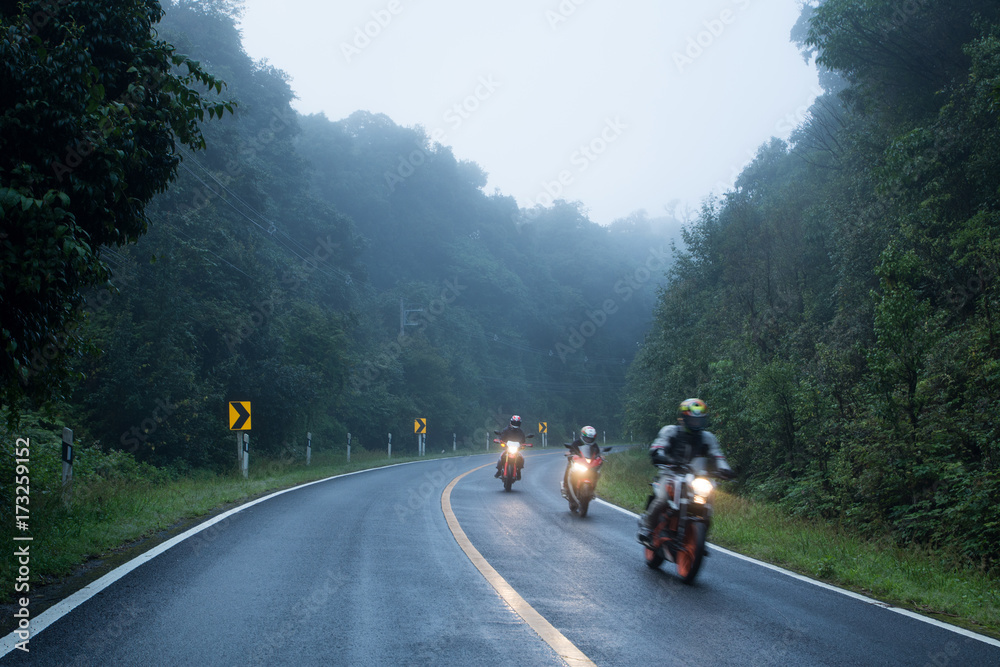 Fototapeta premium Motorcycle on foggy road in mystery land