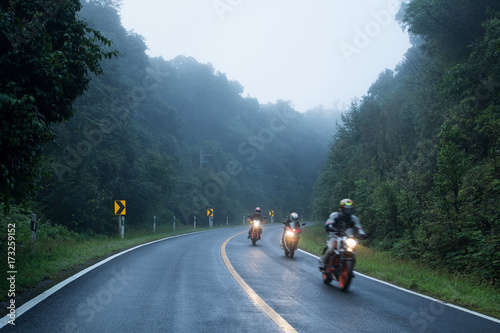 Motorcycle on foggy road in mystery land