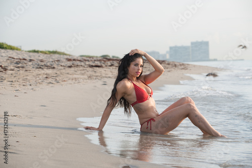 Woman in a swimsuit at the beach.