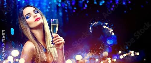 Photography Sexy model girl drinking champagne over holiday glowing background
