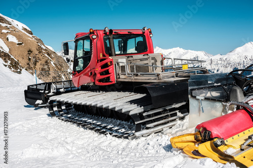 Snow grooming machine (Ratrak). Winter mountain landscape.