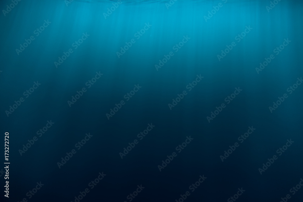 Water texture in underwater and sun rays. Blue ocean in underwater Water texture in underwater and sun rays. Blue ocean in underwater