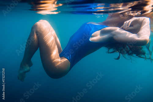 Beautiful woman in bikini  underwater in blue ocean