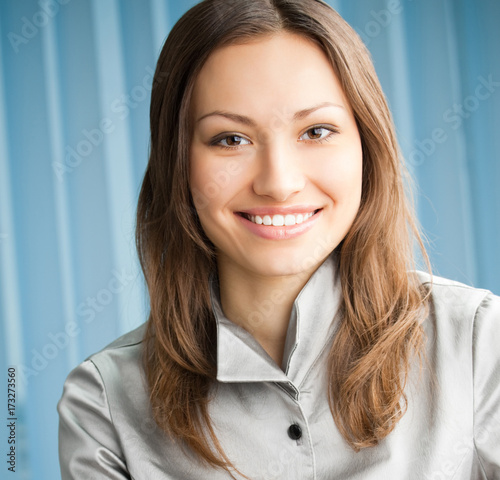 Young cheerful smiling businesswoman